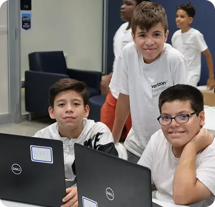 Three boys looking at Dell laptops