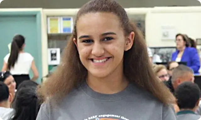 Girl smiling in classroom or library setting