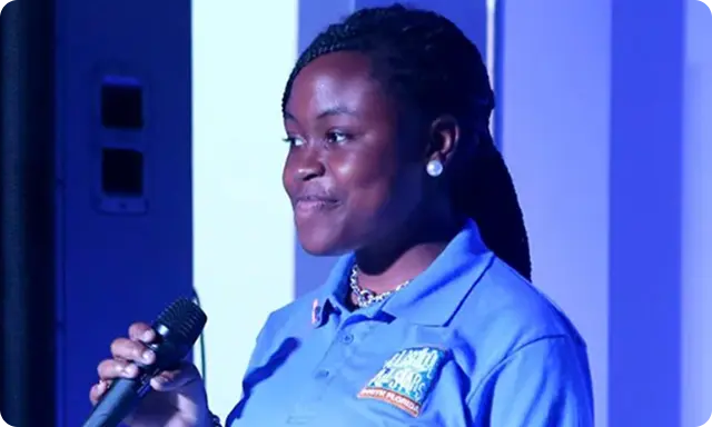 Girl wearing ASAS shirt holding a microphone